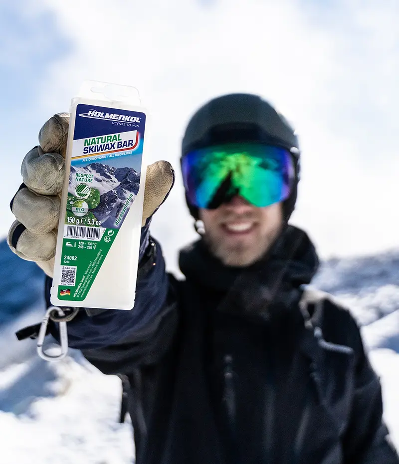 Esquiador sujetando uno de los productos de Holmenkol